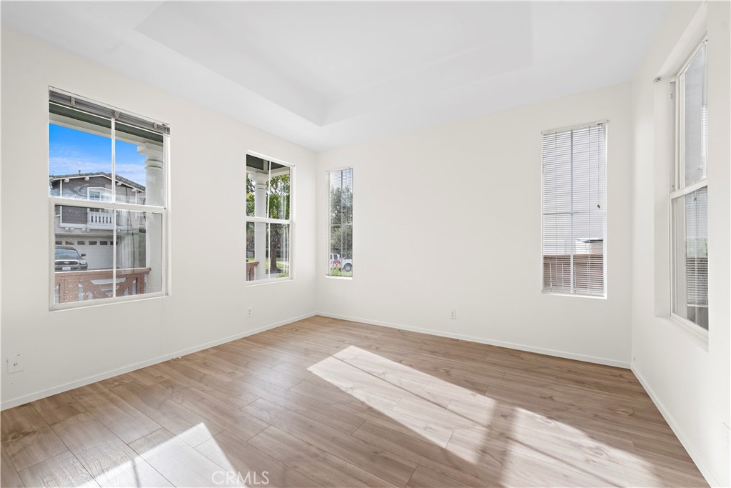 68 Kyle Court Ladera Ranch, CA 92694 - Photo 4 of 33 a view of an empty room with a window and wooden floor