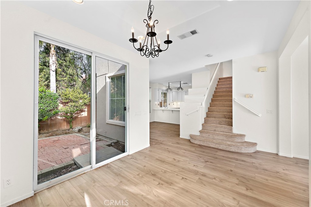 68 Kyle Court Ladera Ranch, CA 92694 - Photo 9 of 33 a view of an entryway with wooden floor and a chandelier