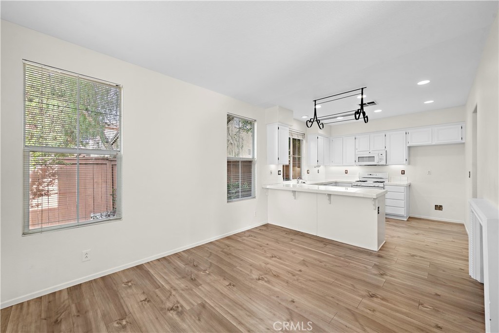 68 Kyle Court Ladera Ranch, CA 92694 - Photo 10 of 33 a view of a kitchen with wooden floor and windows