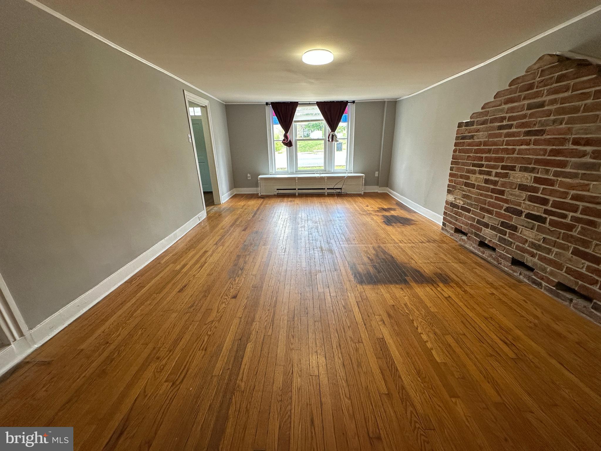 40 North Main Street Boonsboro, MD 21713 - Photo 23 of 75 wooden floor in an empty room with a window
