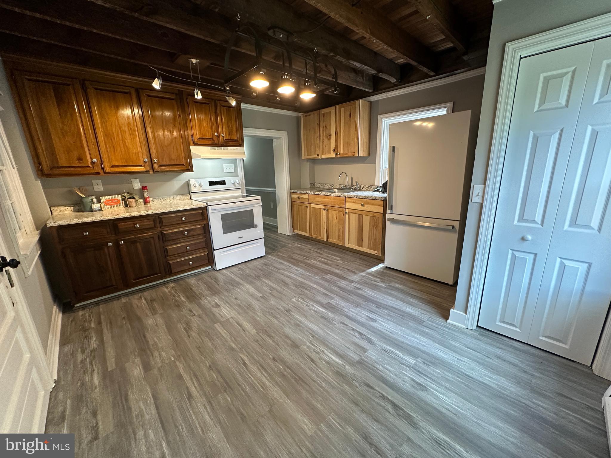 40 North Main Street Boonsboro, MD 21713 - Photo 29 of 75 a kitchen with wooden floors and white stainless steel appliances