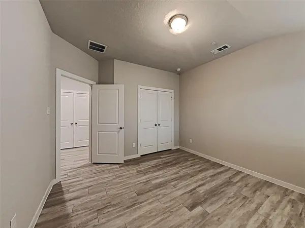 a view of an empty room with glass door