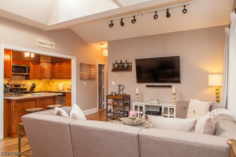 309 1st Street, Unit 3C Hoboken, NJ 07030 - Photo 2 of 12 a living room with furniture and a flat screen tv