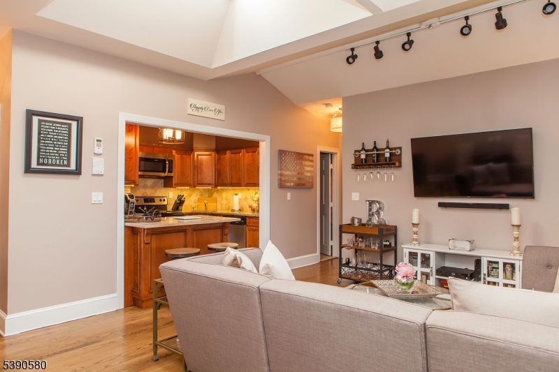 309 1st Street, Unit 3C Hoboken, NJ 07030 - Photo 3 of 12 a living room with furniture and a flat screen tv