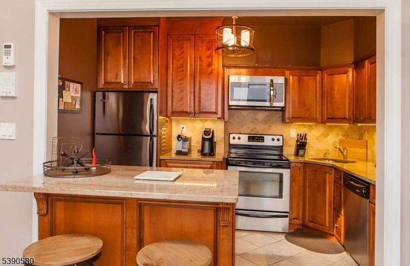 309 1st Street, Unit 3C Hoboken, NJ 07030 - Photo 4 of 12 a kitchen with a sink refrigerator and microwave