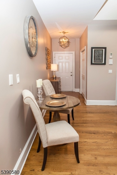 309 1st Street, Unit 3C Hoboken, NJ 07030 - Photo 7 of 12 a view of a room with a table and chairs