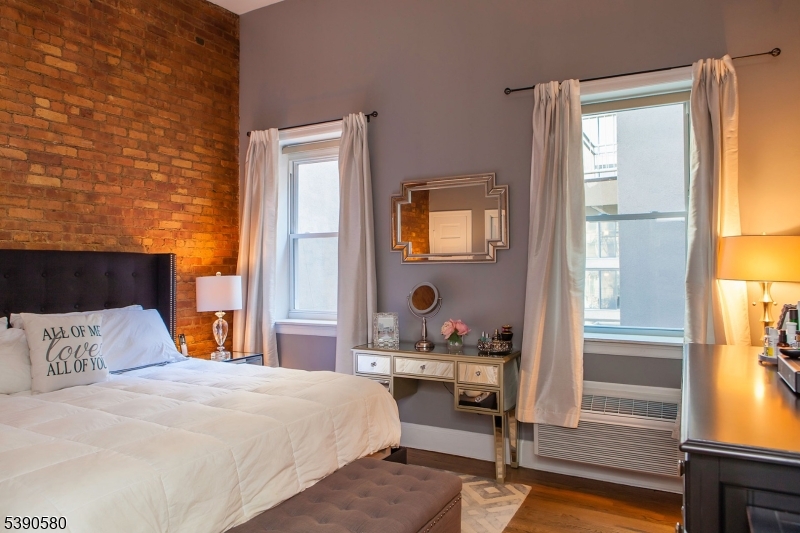 309 1st Street, Unit 3C Hoboken, NJ 07030 - Photo 8 of 12 a bedroom with a bed and wooden floor