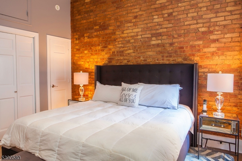 309 1st Street, Unit 3C Hoboken, NJ 07030 - Photo 9 of 12 a bedroom with a bed and a night stand