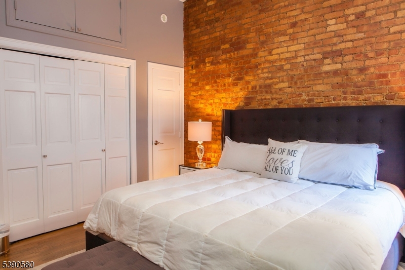 309 1st Street, Unit 3C Hoboken, NJ 07030 - Photo 10 of 12 a large bed sitting in a bedroom next to a window