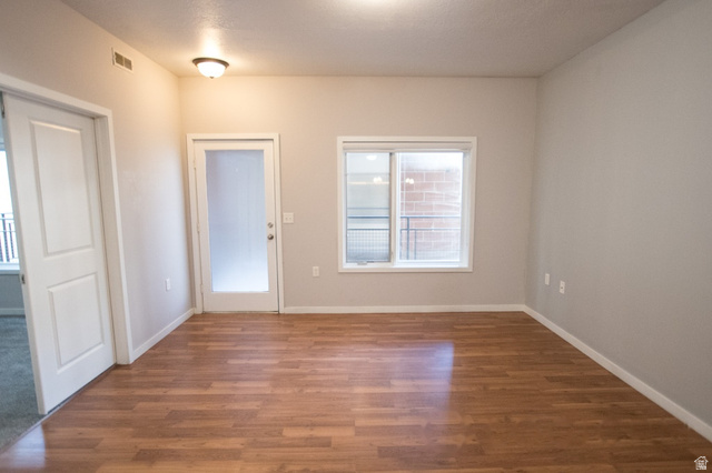 2150 South Main Street, Unit R405 Salt Lake City, UT 84115 - Photo 4 of 20 Wood-finish flooring throughout, featuring a frosted glass panel door and a double-pane window
