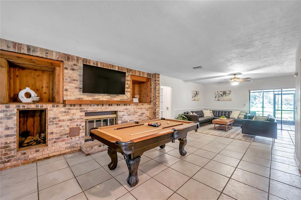7405 Williams Road Seffner, FL 33584 - Photo 17 of 100 a living room with furniture and a flat screen tv