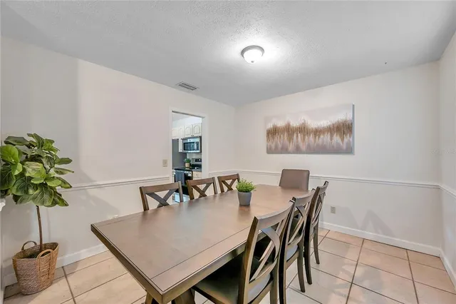 a bedroom with a bed a couch and a flat screen tv