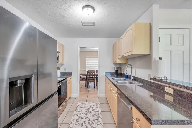 a view of a bedroom with baby bed and closet