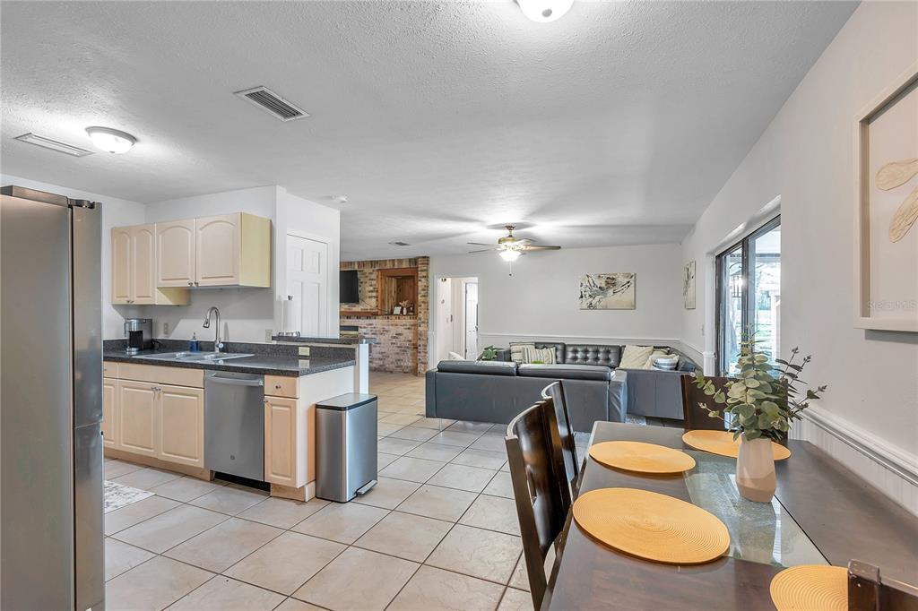 7405 Williams Road Seffner, FL 33584 - Photo 31 of 100 a kitchen with stainless steel appliances granite countertop a stove a sink a stove a dining table and chairs