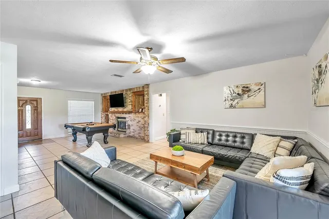 a living room with furniture and a floor to ceiling window