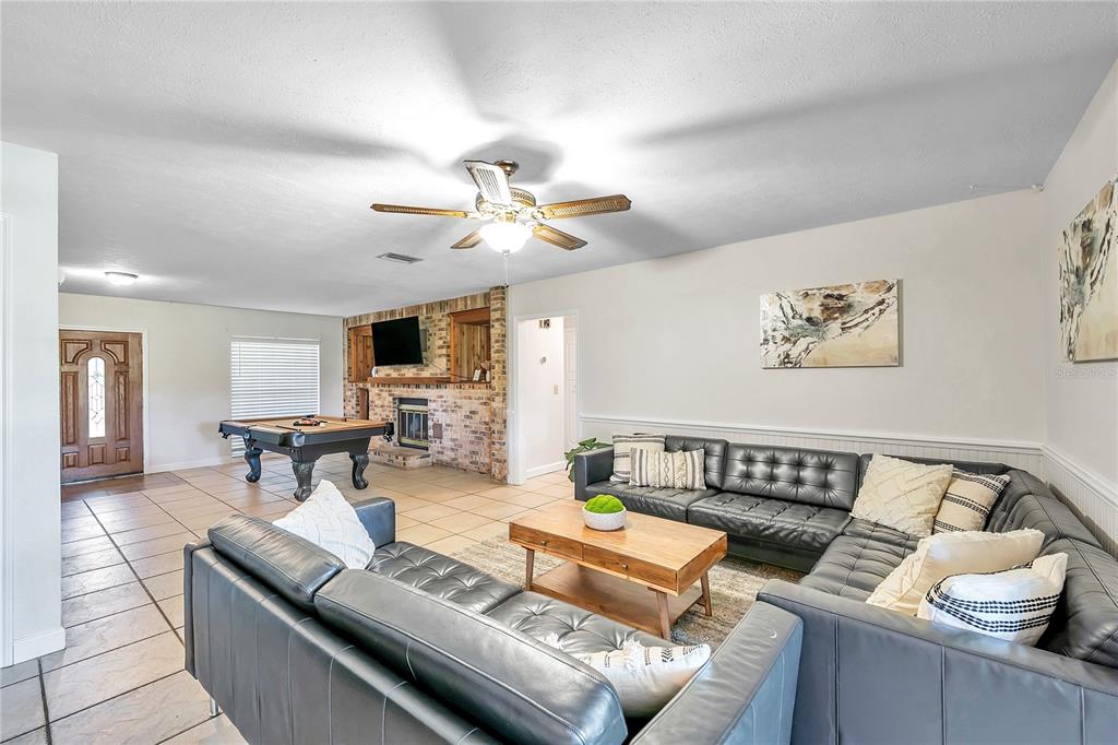 7405 Williams Road Seffner, FL 33584 - Photo 33 of 100 a living room with furniture and wooden floor