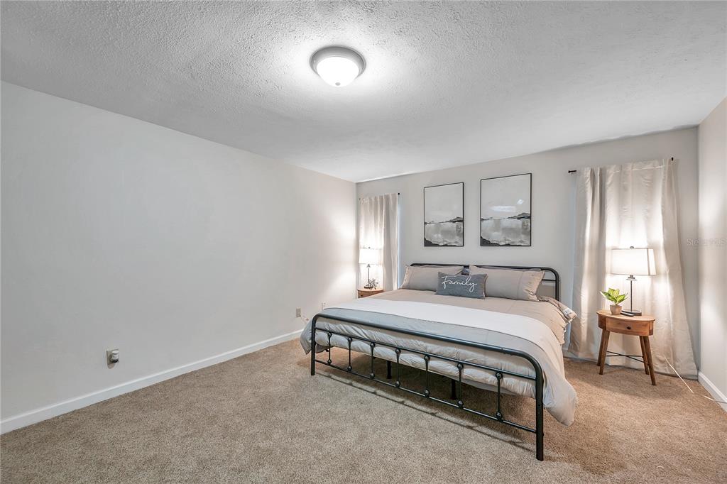 7405 Williams Road Seffner, FL 33584 - Photo 40 of 100 a bedroom with a bed and a table