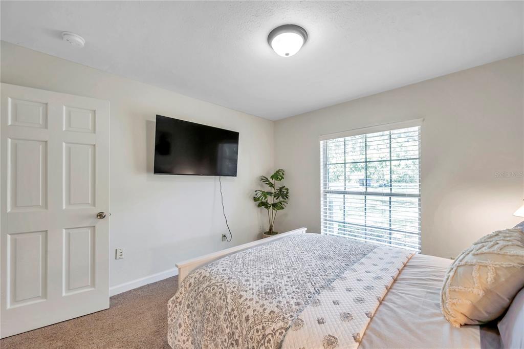 7405 Williams Road Seffner, FL 33584 - Photo 53 of 100 a bedroom with a bed and a flat screen tv