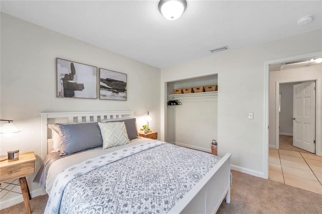 7405 Williams Road Seffner, FL 33584 - Photo 54 of 100 a bedroom with a bed and a painting on the wall