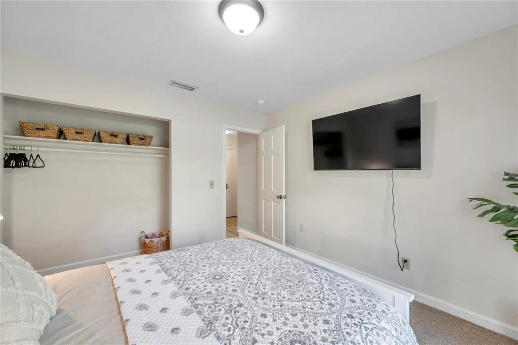 7405 Williams Road Seffner, FL 33584 - Photo 55 of 100 a bedroom with a bed and a flat screen tv