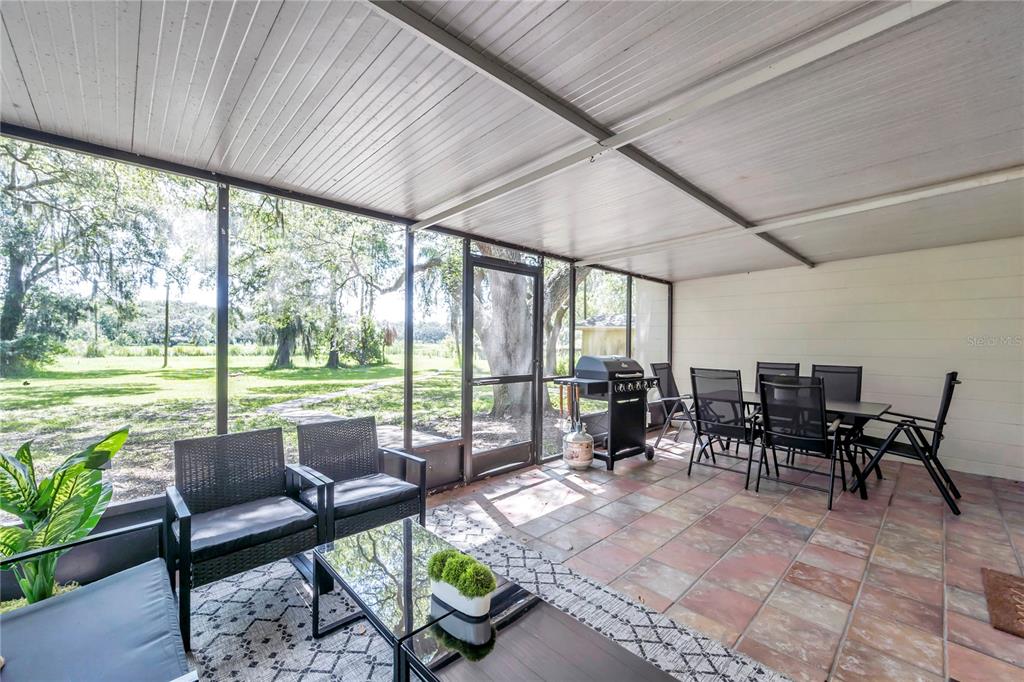 7405 Williams Road Seffner, FL 33584 - Photo 58 of 100 a living room with furniture and a floor to ceiling window