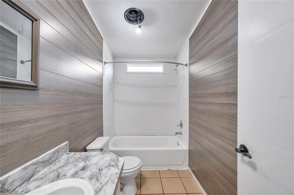 7405 Williams Road Seffner, FL 33584 - Photo 85 of 100 a bathroom with a bathtub and shower