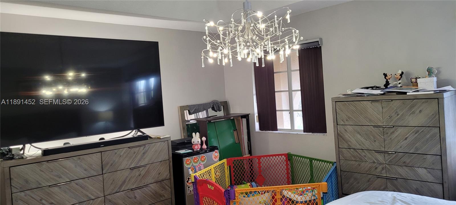 13661 Southwest 119th Avenue Miami, FL 33186 - Photo 14 of 36 a living room with furniture and a flat screen tv