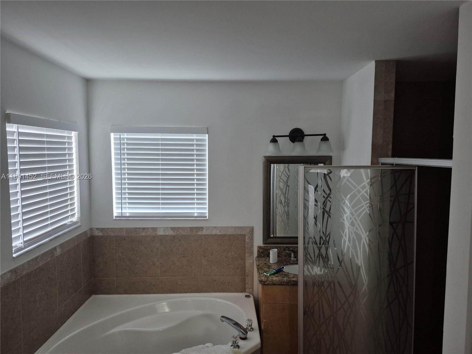 13661 Southwest 119th Avenue Miami, FL 33186 - Photo 15 of 36 a bathroom with a bathtub and a window