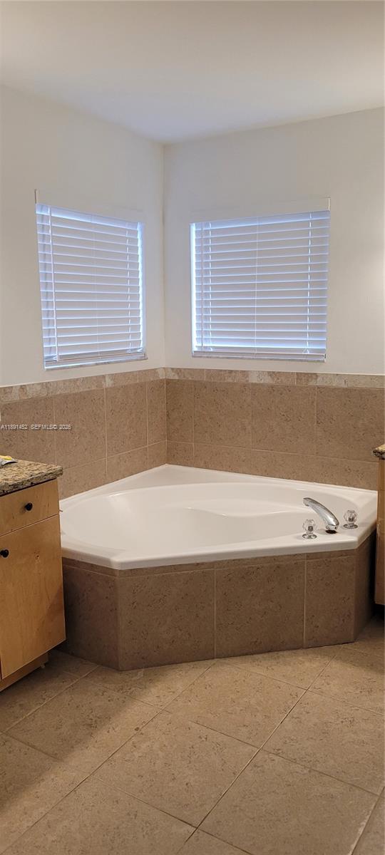 13661 Southwest 119th Avenue Miami, FL 33186 - Photo 16 of 36 a bathroom with a bathtub and a window