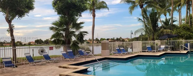 aerial view of a house with a yard and potted plants