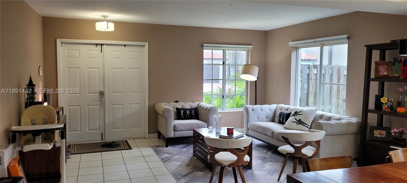 13661 Southwest 119th Avenue Miami, FL 33186 - Photo 3 of 36 a living room with furniture and a window