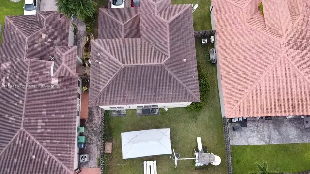 a aerial view of a house with a yard