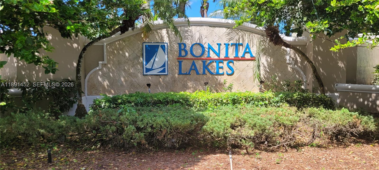 13661 Southwest 119th Avenue Miami, FL 33186 - Photo 35 of 36 a sign that is on a bunch of plants