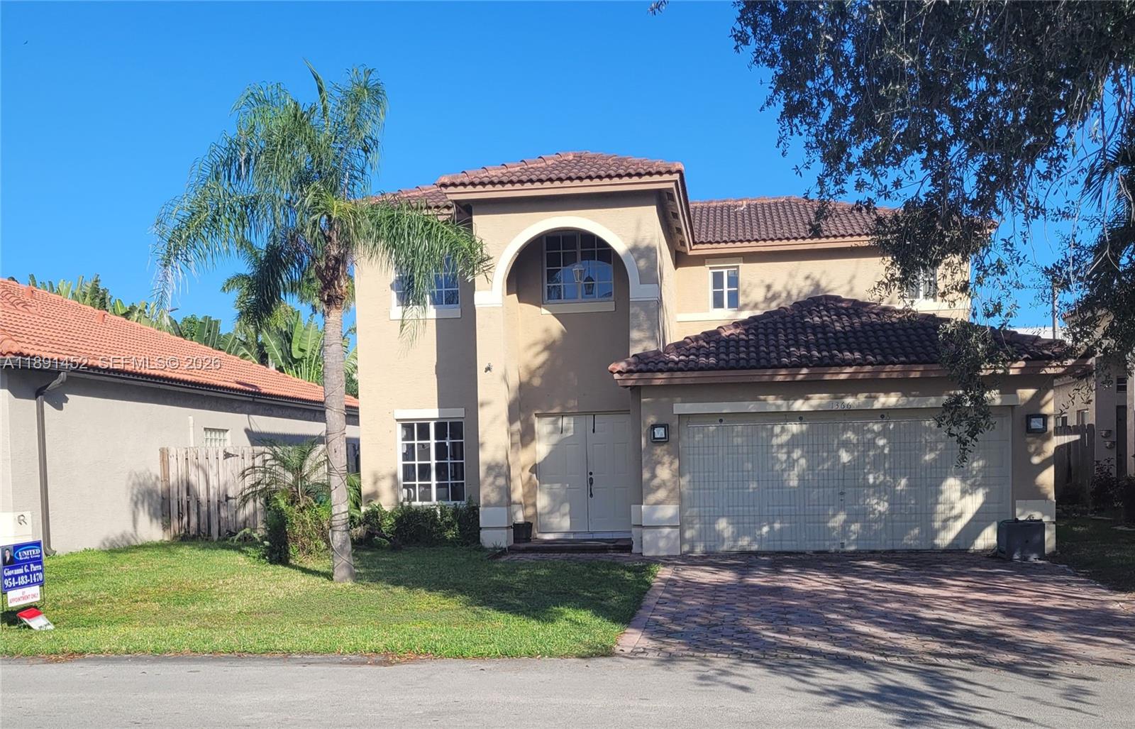 13661 Southwest 119th Avenue Miami, FL 33186 - Photo 36 of 36 a front view of a house with a garden and plants