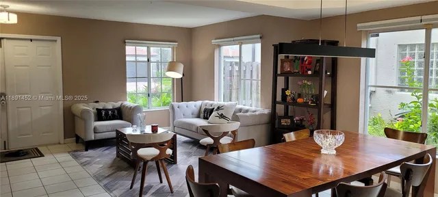 a view of a dining room with furniture and window