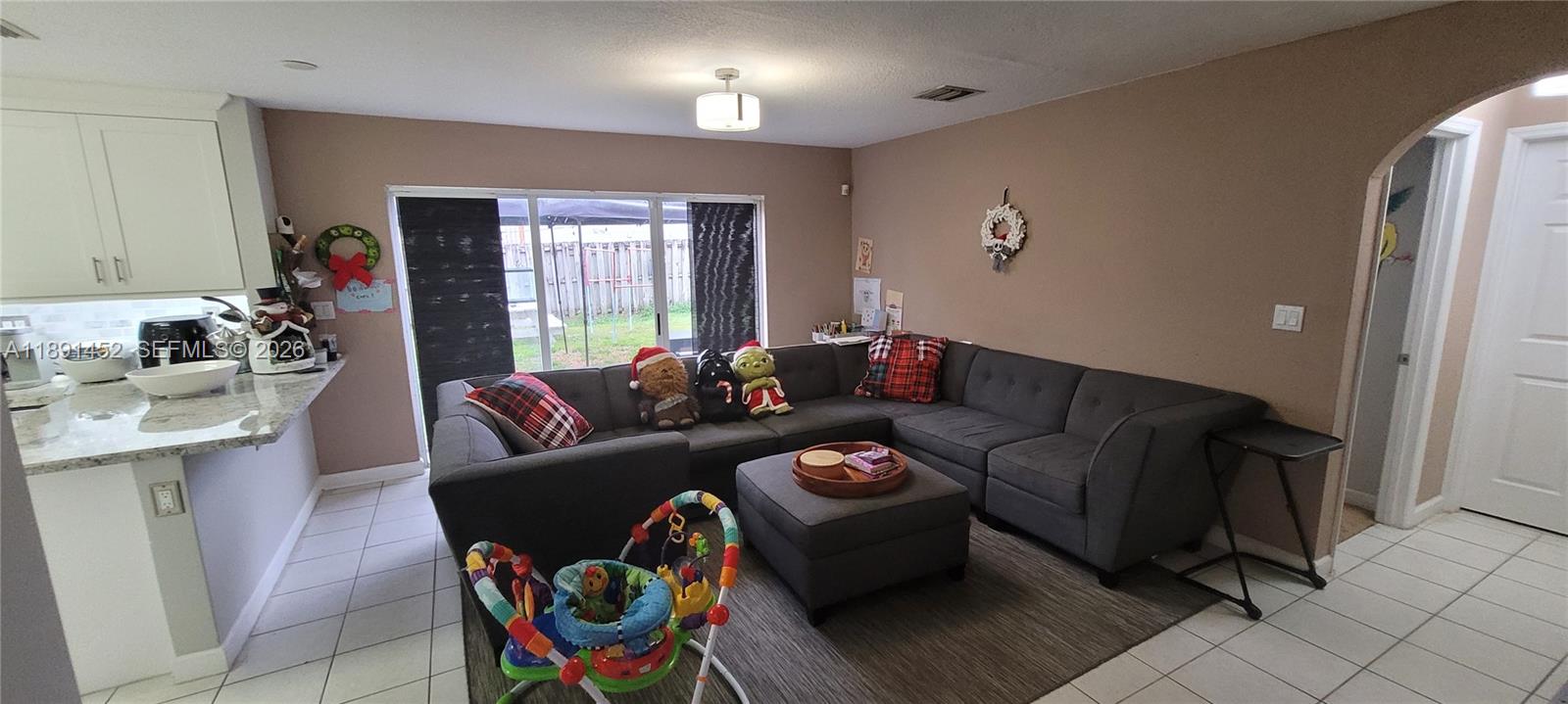 13661 Southwest 119th Avenue Miami, FL 33186 - Photo 8 of 36 a living room with furniture and a large window