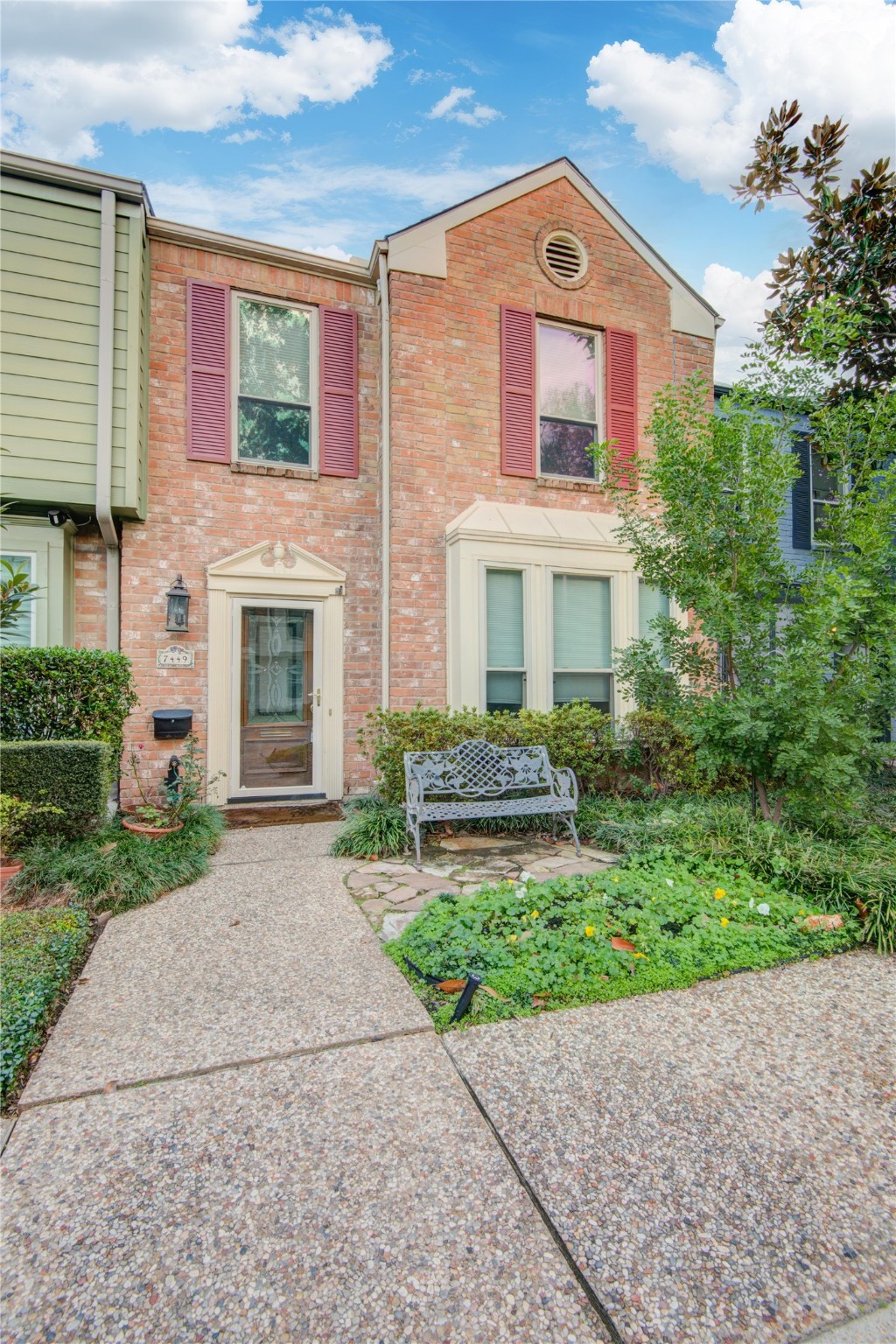 7449 Brompton Street, Unit 7449 Houston, TX 77025 - Photo 2 of 46 a front view of a house with a yard and garage
