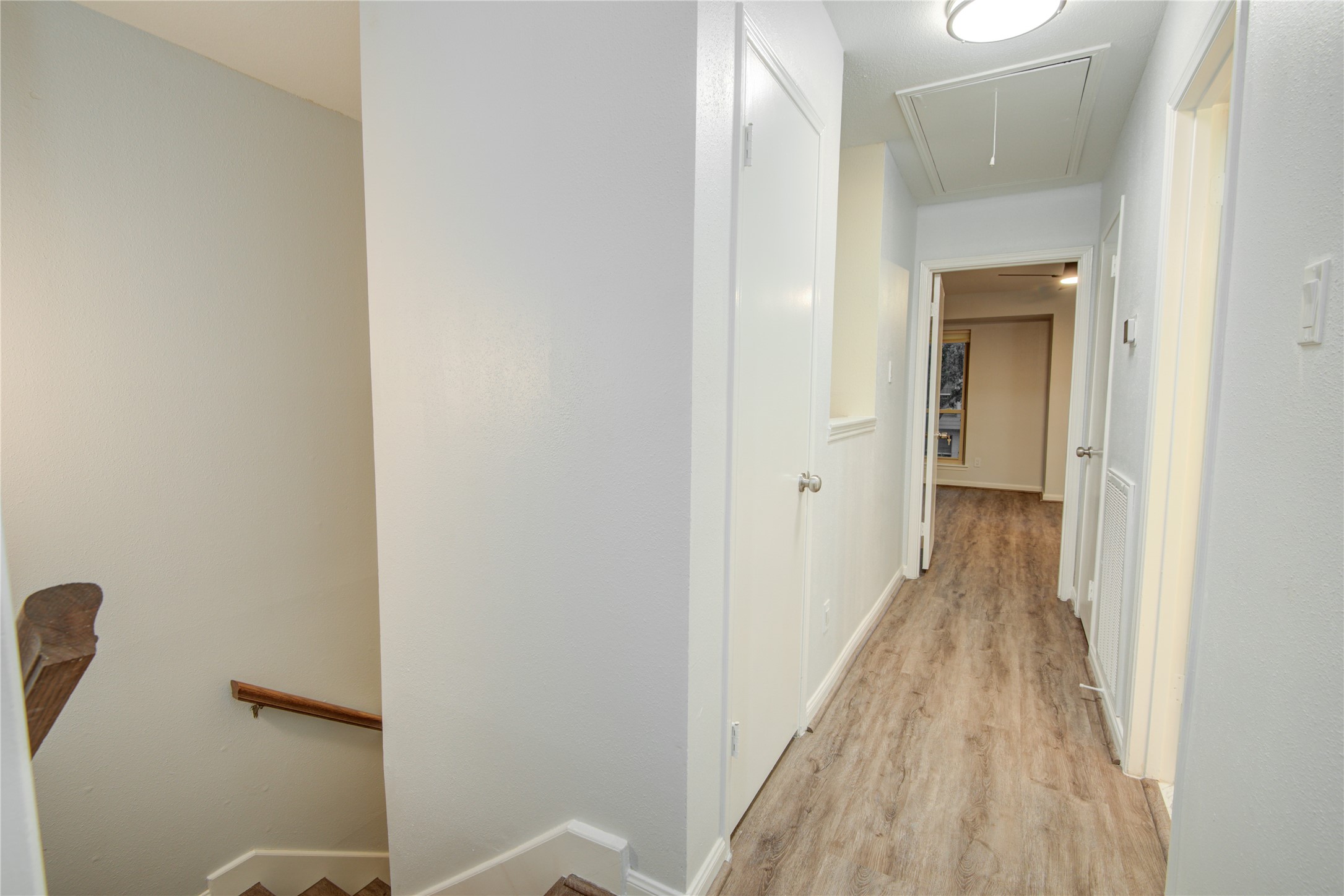 7449 Brompton Street, Unit 7449 Houston, TX 77025 - Photo 26 of 46 a view of a hallway with wooden floor