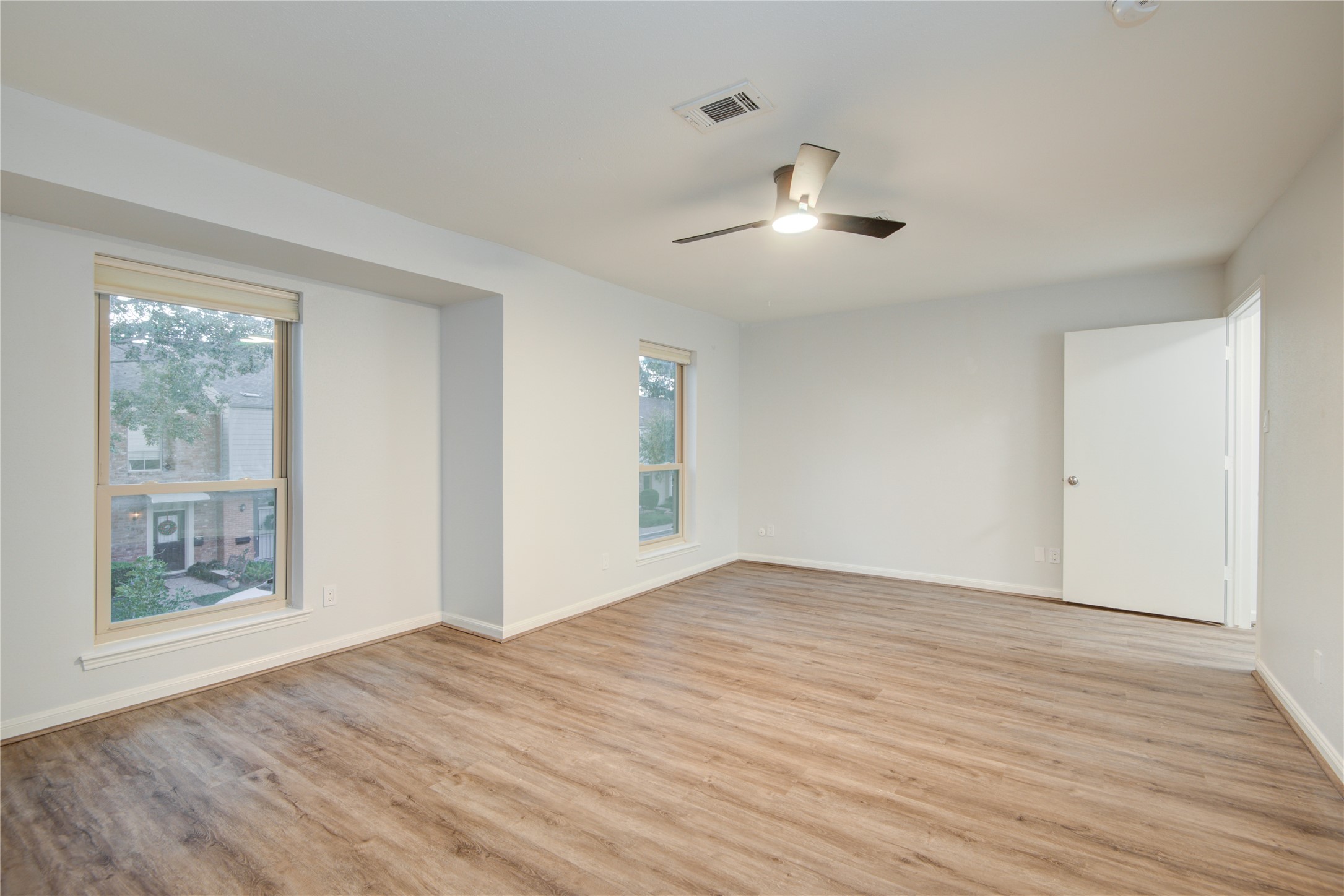 7449 Brompton Street, Unit 7449 Houston, TX 77025 - Photo 28 of 46 a view of an empty room with wooden floor and a window