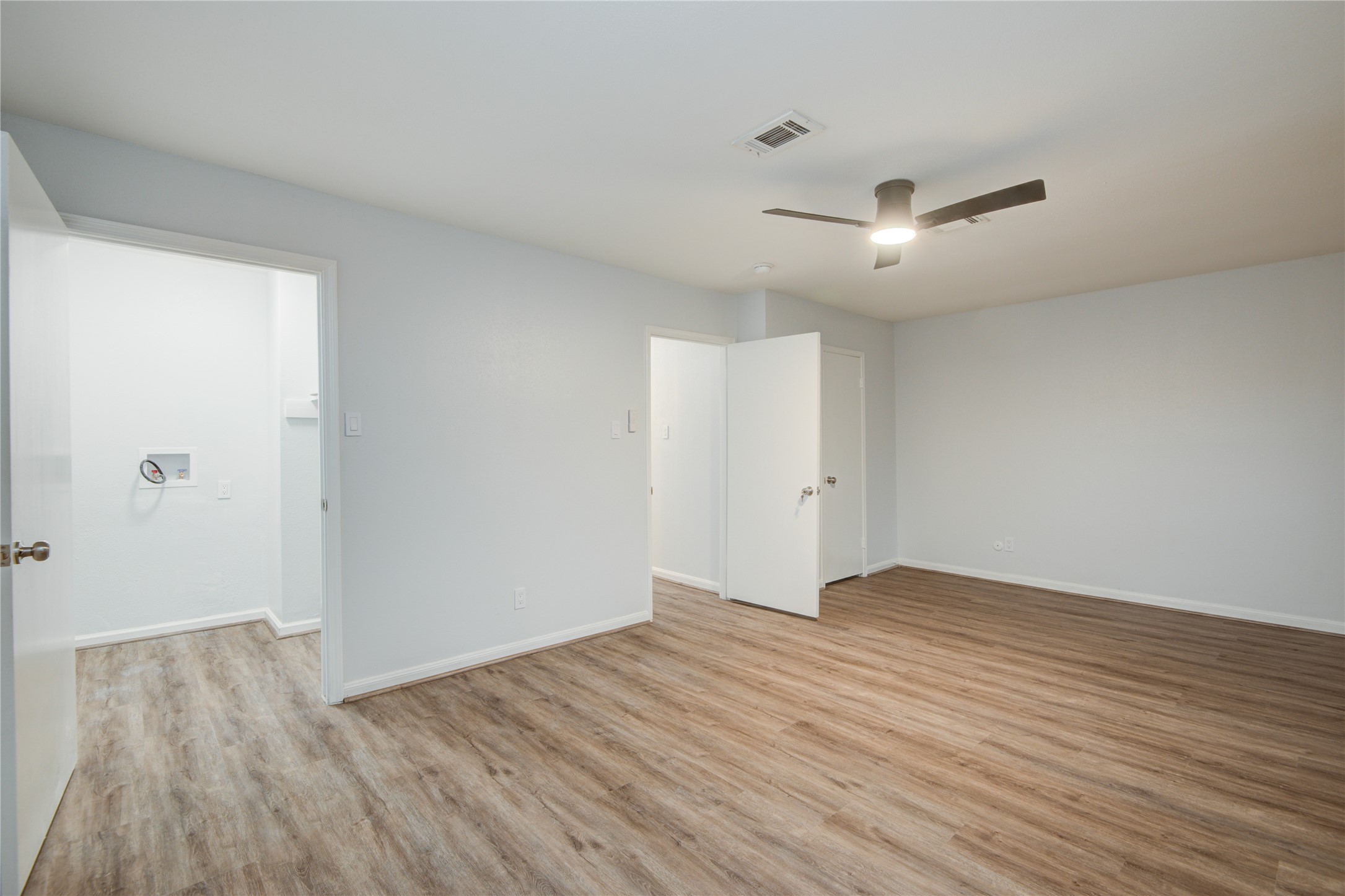 7449 Brompton Street, Unit 7449 Houston, TX 77025 - Photo 29 of 46 an empty room with wooden floor and windows