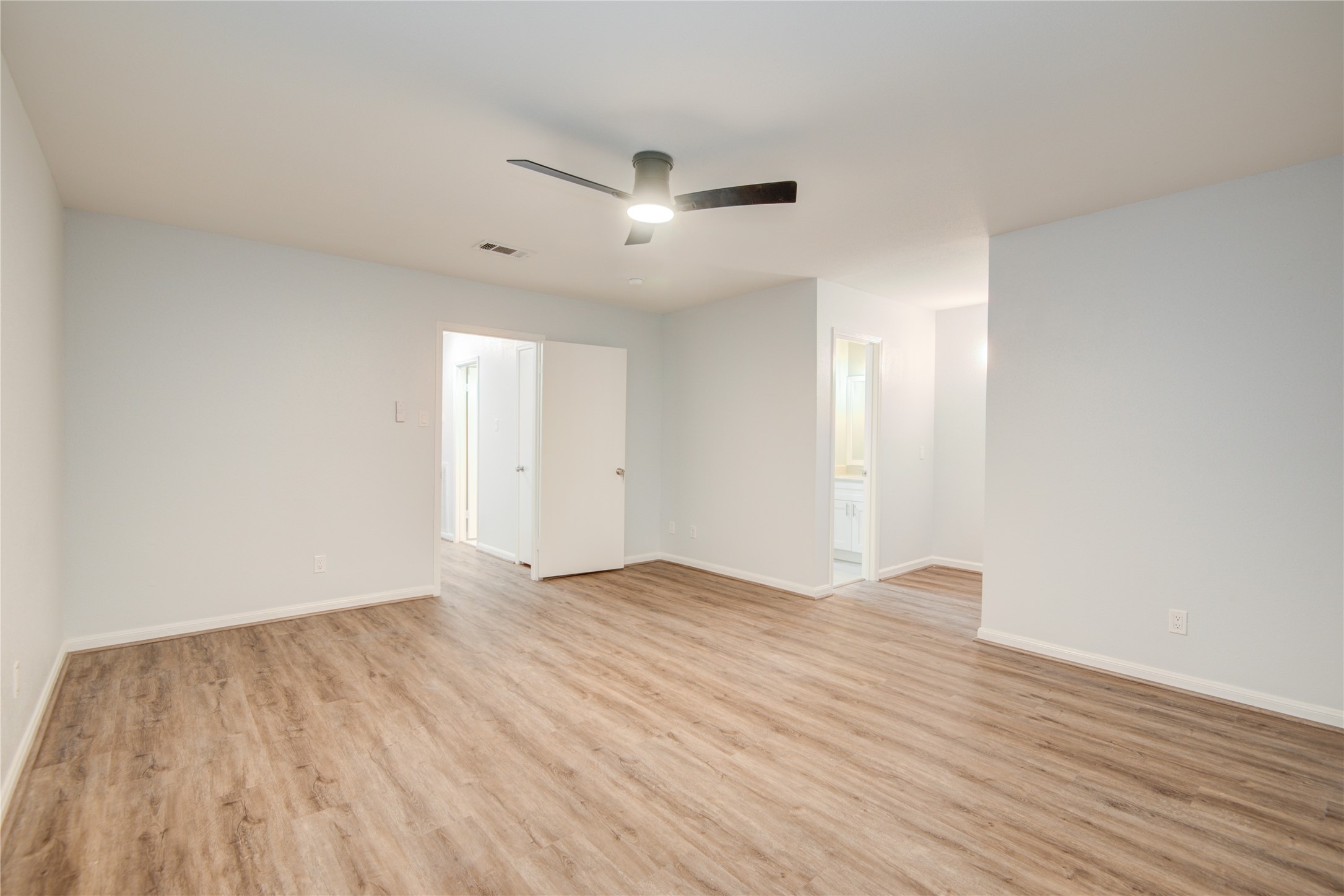 7449 Brompton Street, Unit 7449 Houston, TX 77025 - Photo 33 of 46 an empty room with wooden floor and windows