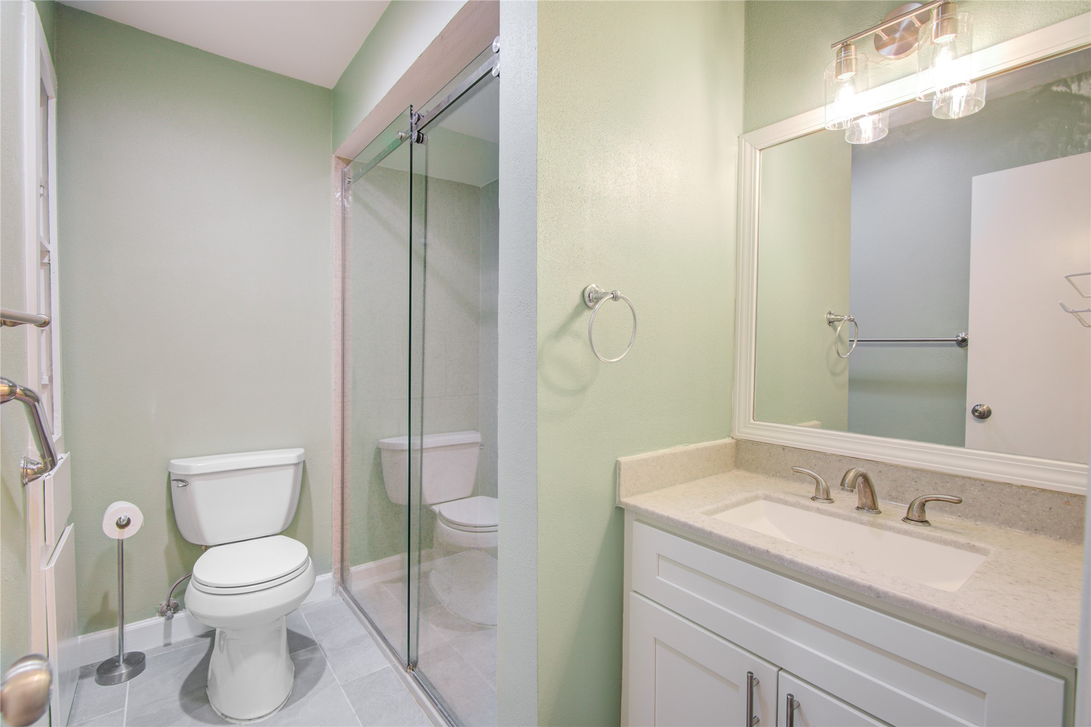 7449 Brompton Street, Unit 7449 Houston, TX 77025 - Photo 35 of 46 a bathroom with a granite countertop sink toilet and shower