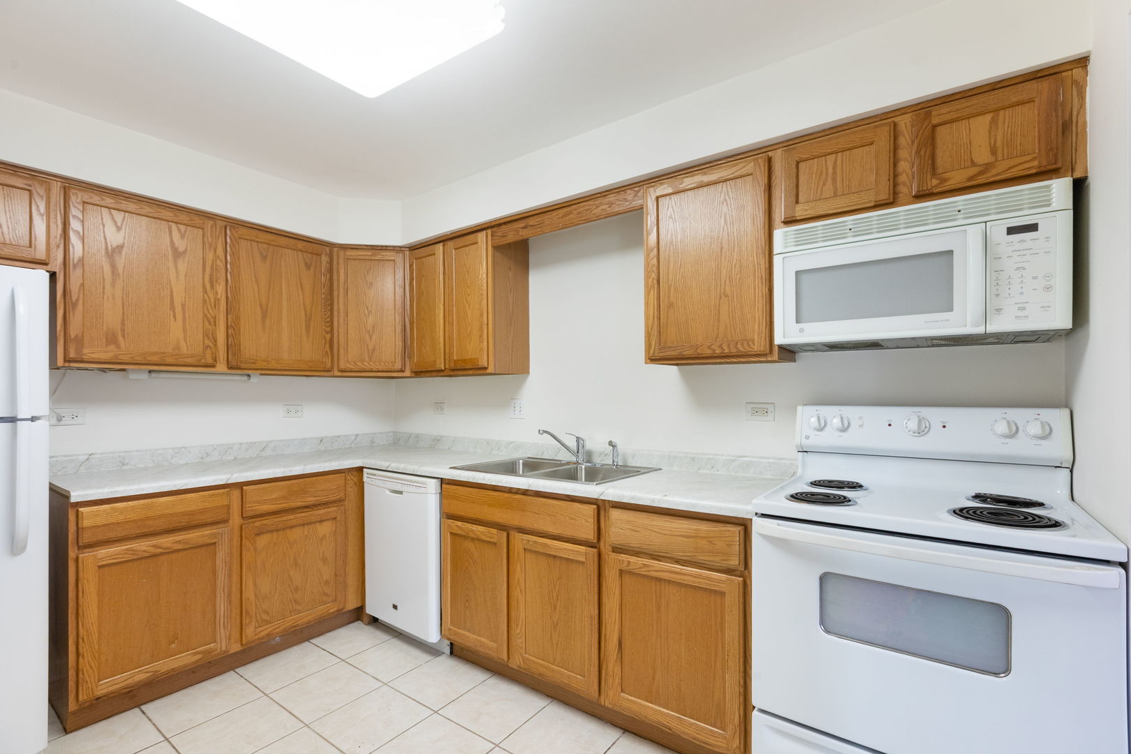 435 Ridge Road, Unit 108 Wilmette, IL 60091 - Photo 5 of 18 a kitchen with a sink dishwasher stove and cabinets