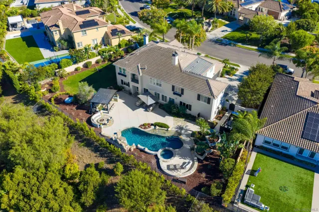 an aerial view of house with yard swimming pool and outdoor seating