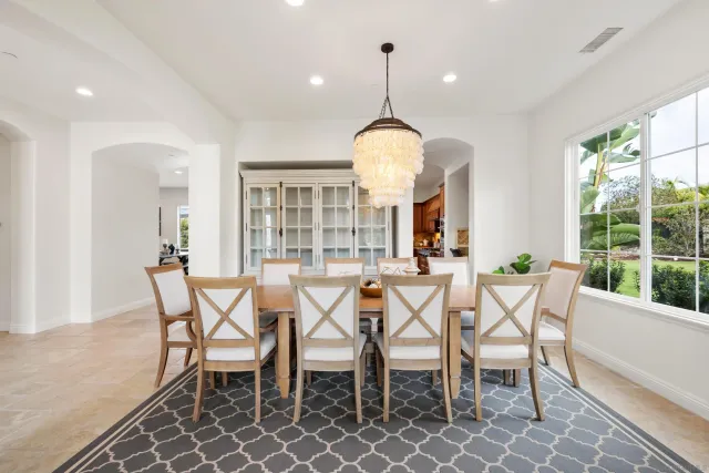 a view of a dining room with furniture wooden floor and chandelier