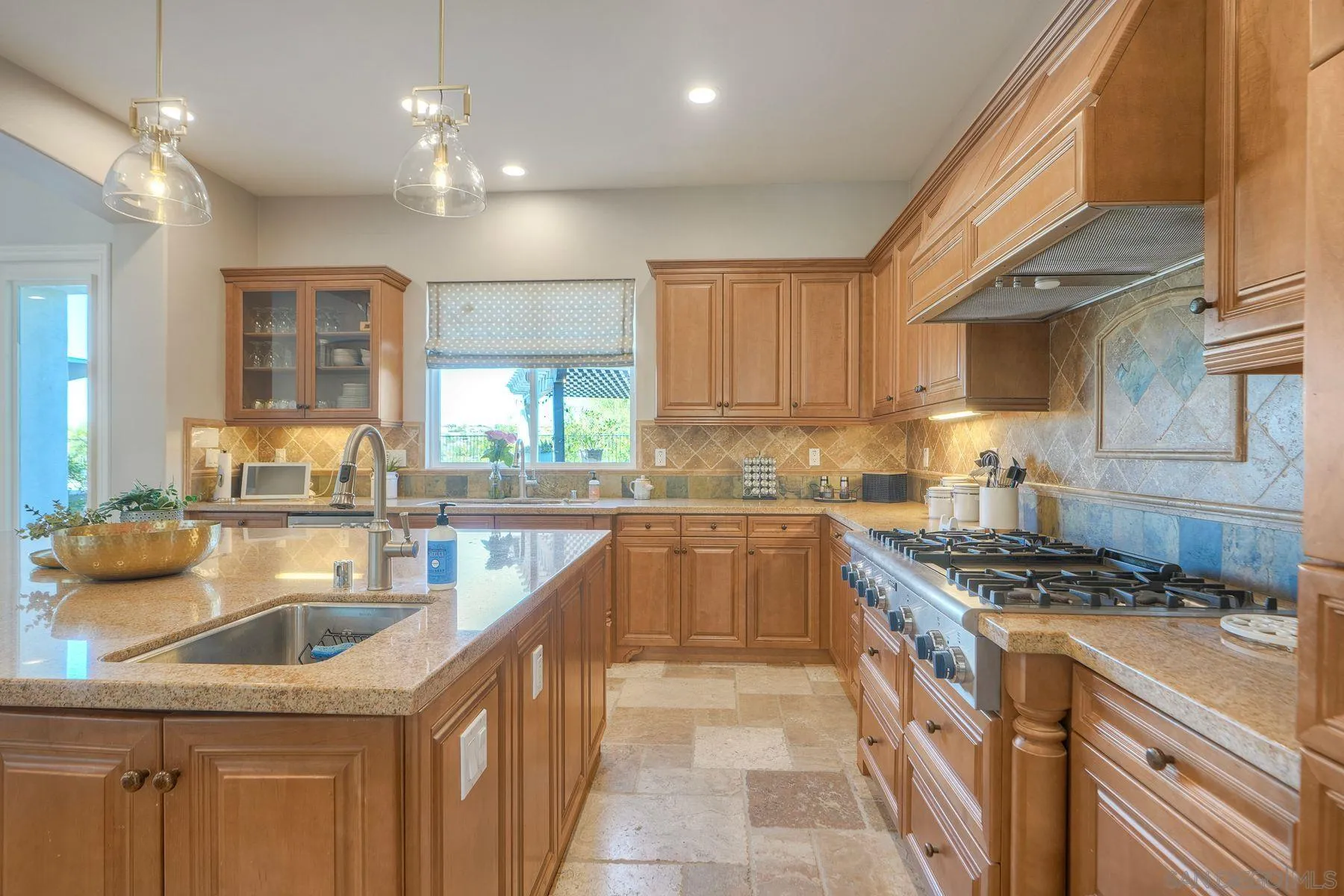10055 Winecrest Road San Diego, CA 92127 - Photo 16 of 34 a kitchen with a sink stove and cabinets