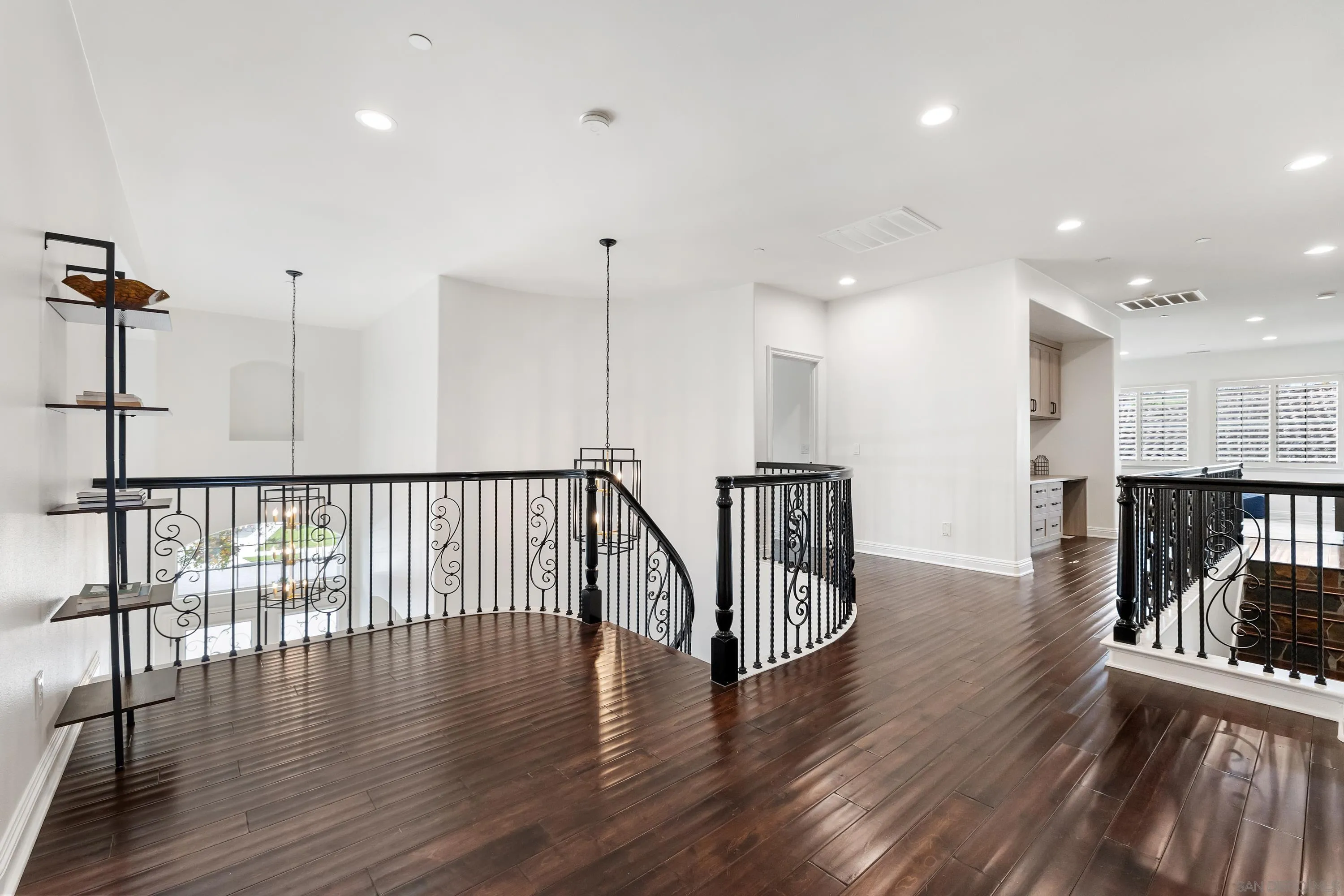 10055 Winecrest Road San Diego, CA 92127 - Photo 19 of 34 a view of a hallway with wooden floor and fence