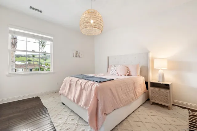 a bedroom with a bed and a window