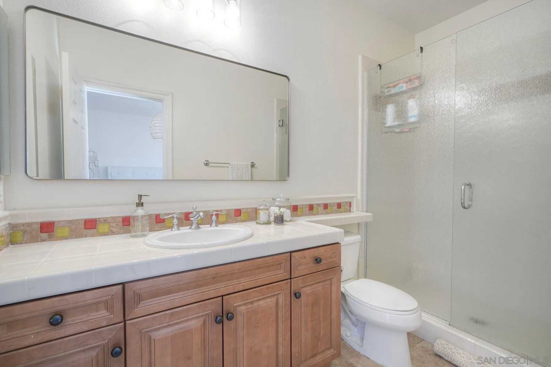 10055 Winecrest Road San Diego, CA 92127 - Photo 27 of 34 a bathroom with a sink a toilet and a mirror