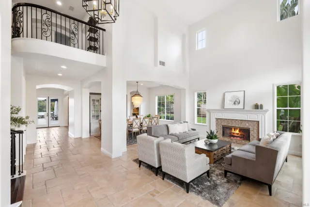 a living room with furniture fireplace and a chandelier